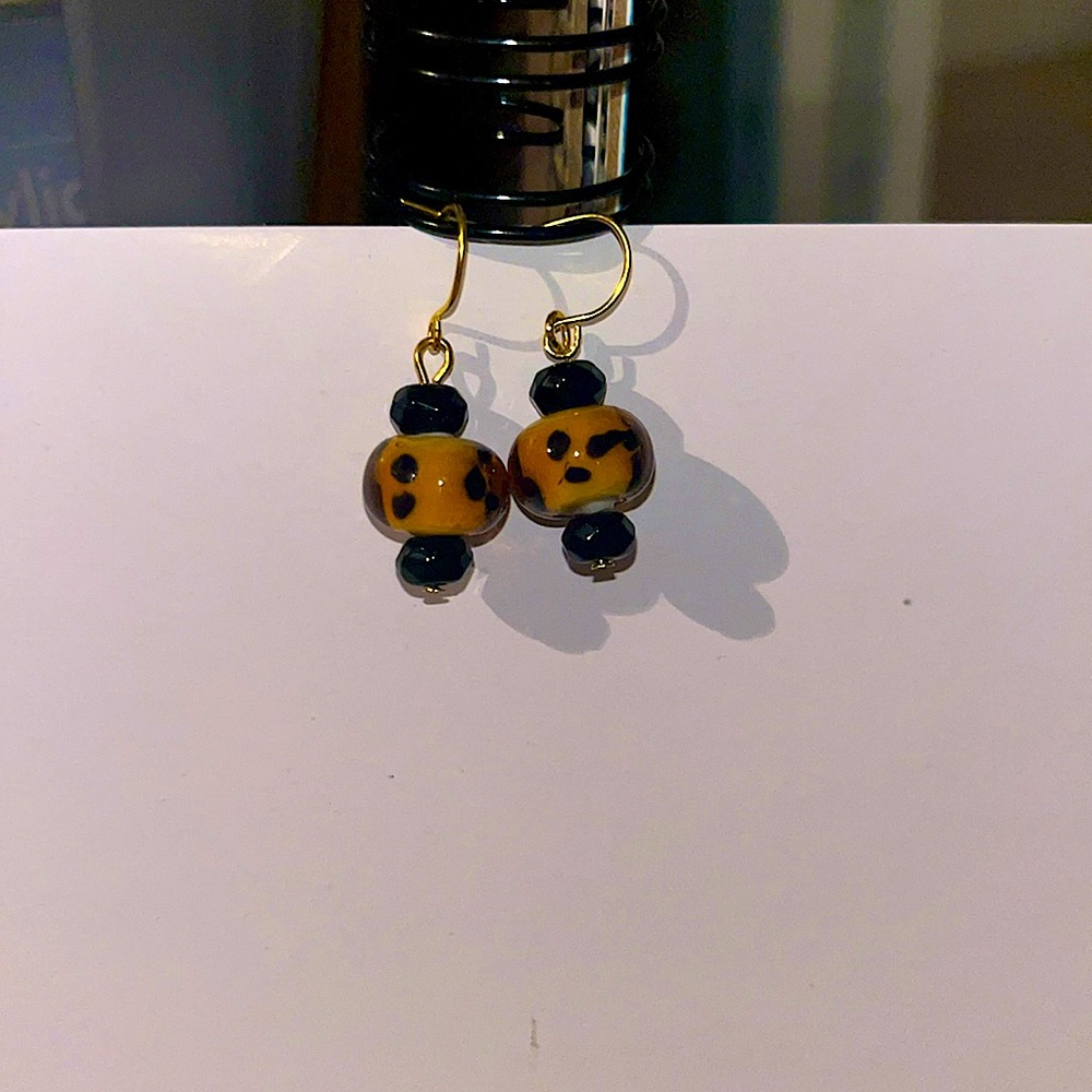 Gold dangly earrings. Cheetah print beads.